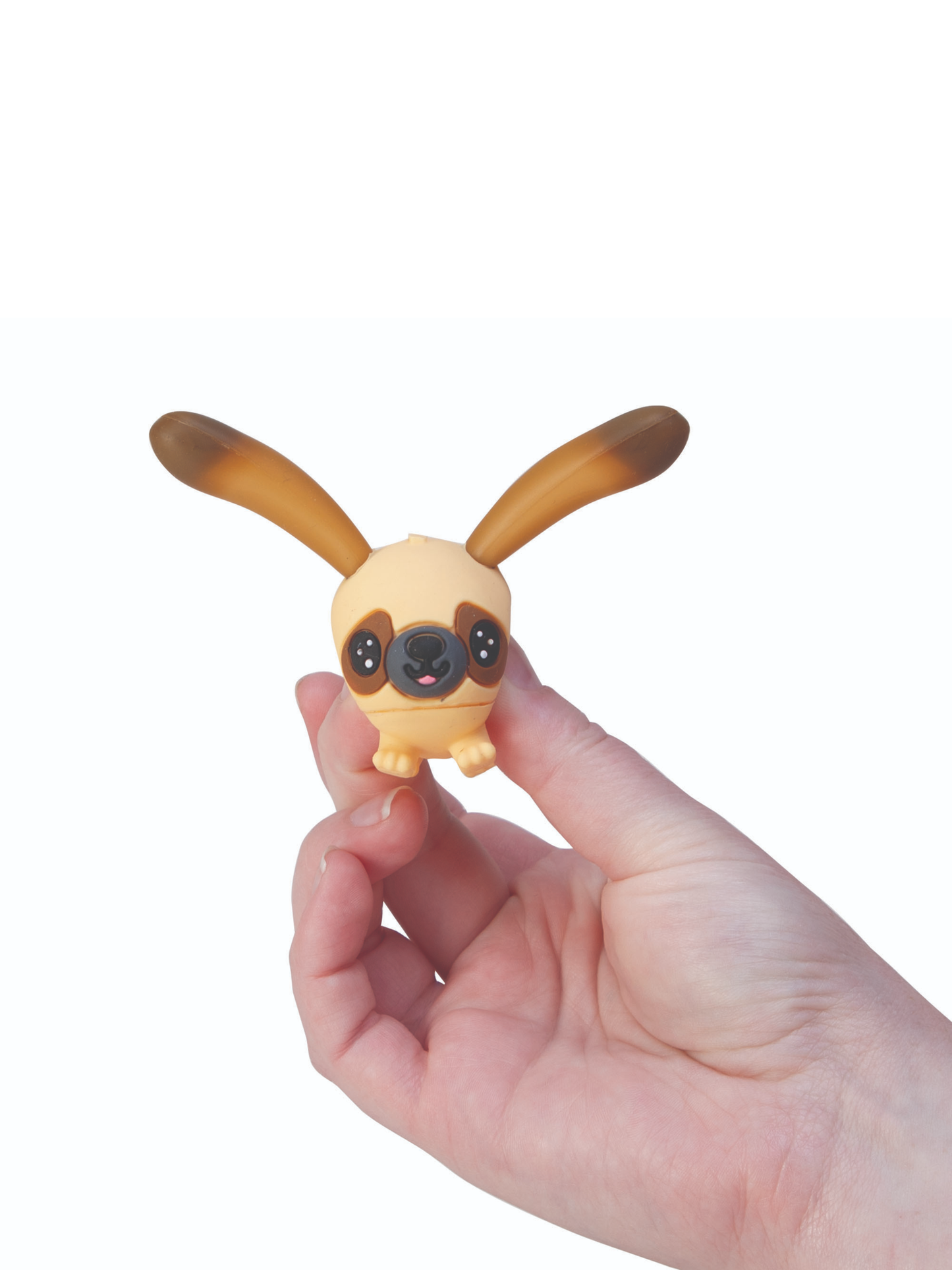 Hand holding small tan pug dog toy figure with large brown floppy ears