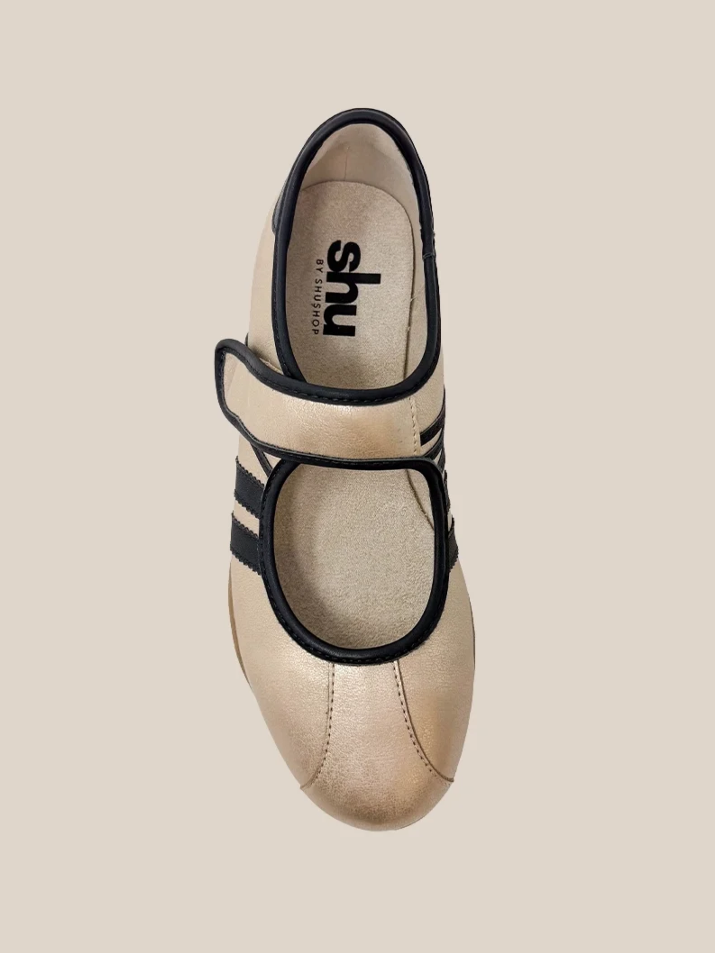 Gold metallic Mary Jane flat sneaker with black trim straps and retro side stripes