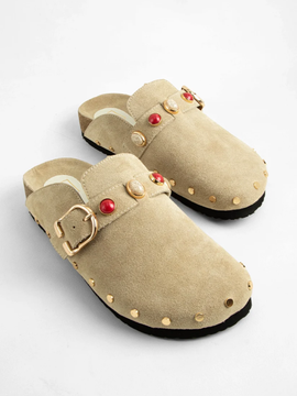 Beige suede studded clogs with gold buckle strap and red stone embellishments