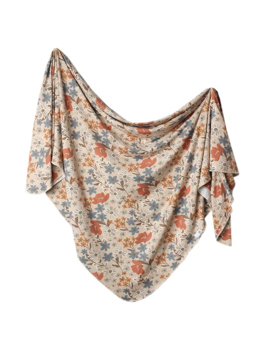 Copper Pearl Eden swaddle blanket, beige with rust, blue, and gold floral print