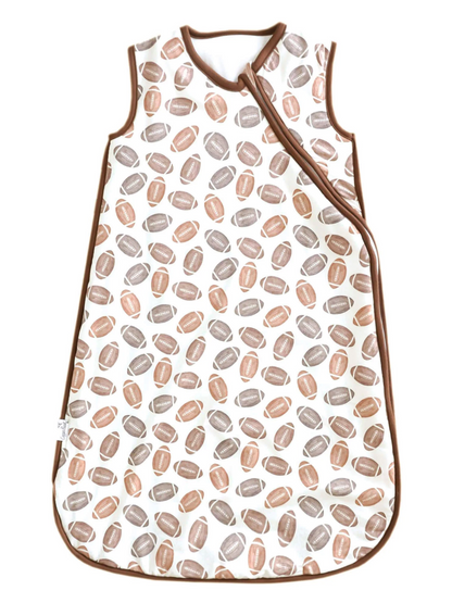 White baby sleep sack with brown and tan football print and brown trim