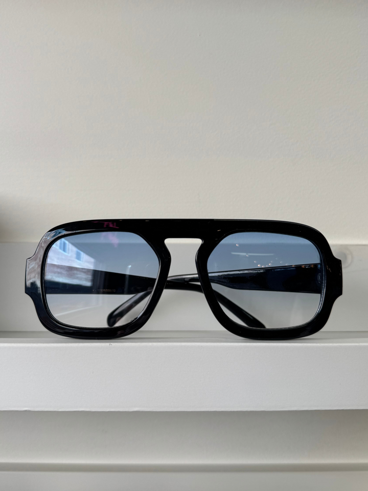 large retro style sunglasses with black frame and blue lens