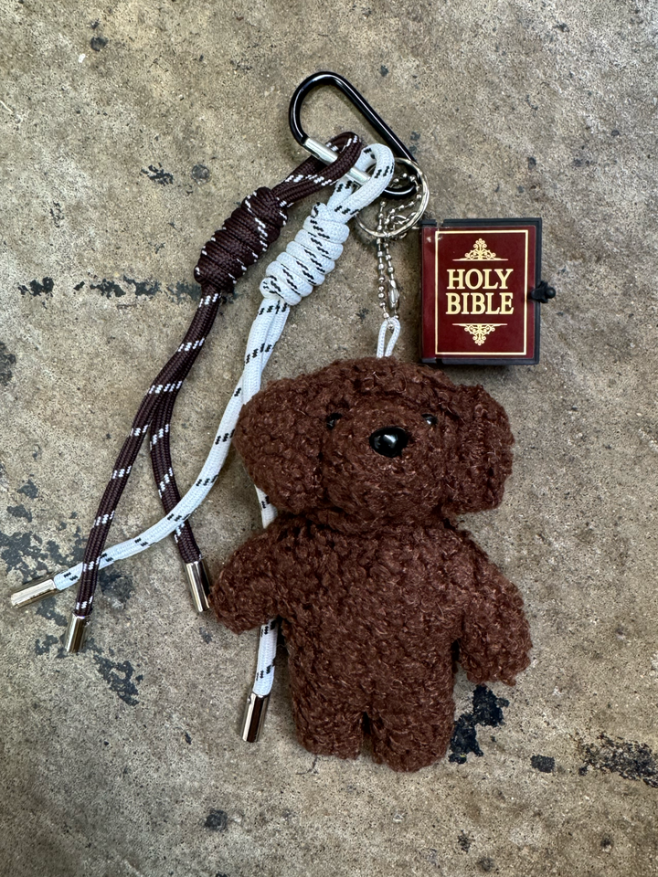 keychain with brown and white rope charms, small stuffed brown puppy and a mini bible
