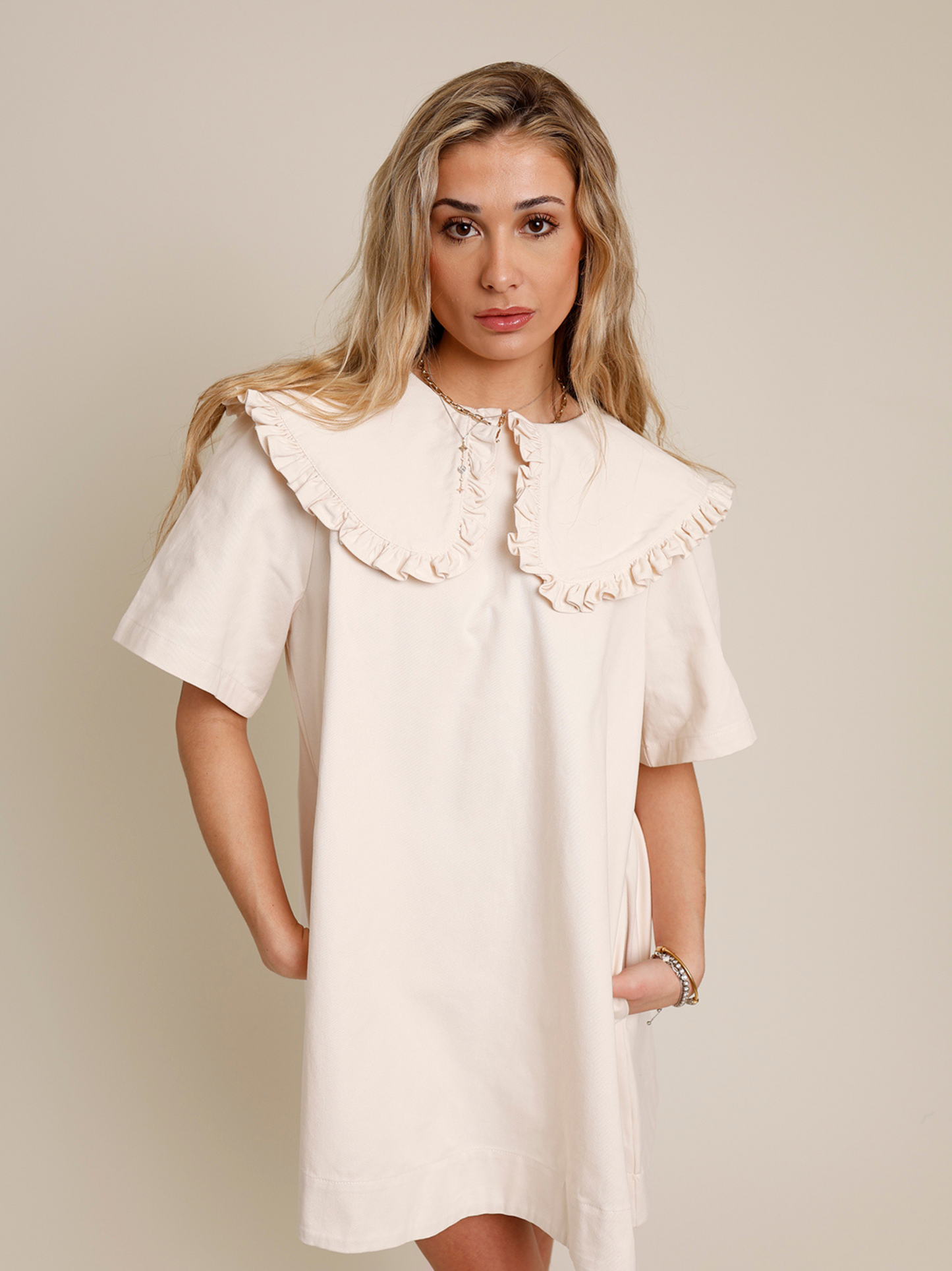 Cream mini dress with oversized ruffle collar and short sleeves