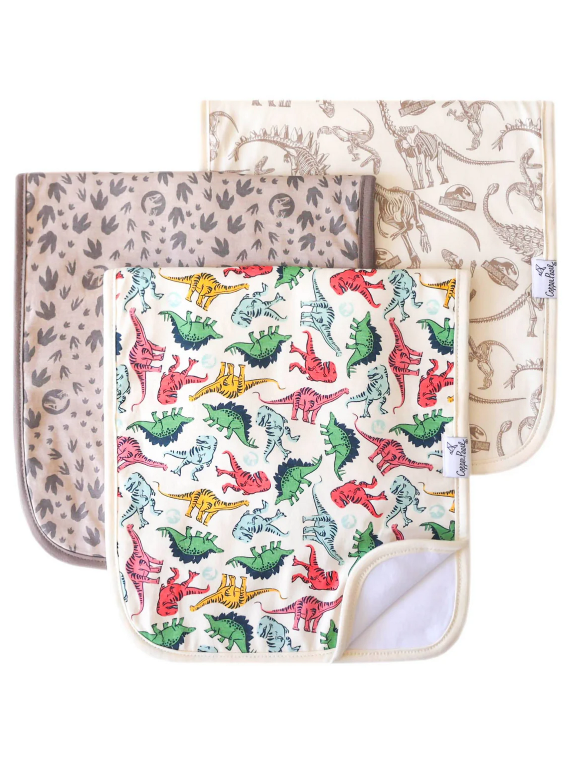 Three dinosaur-print baby burp cloths: colorful dinos, fossil skeletons, and dino footprints patterns