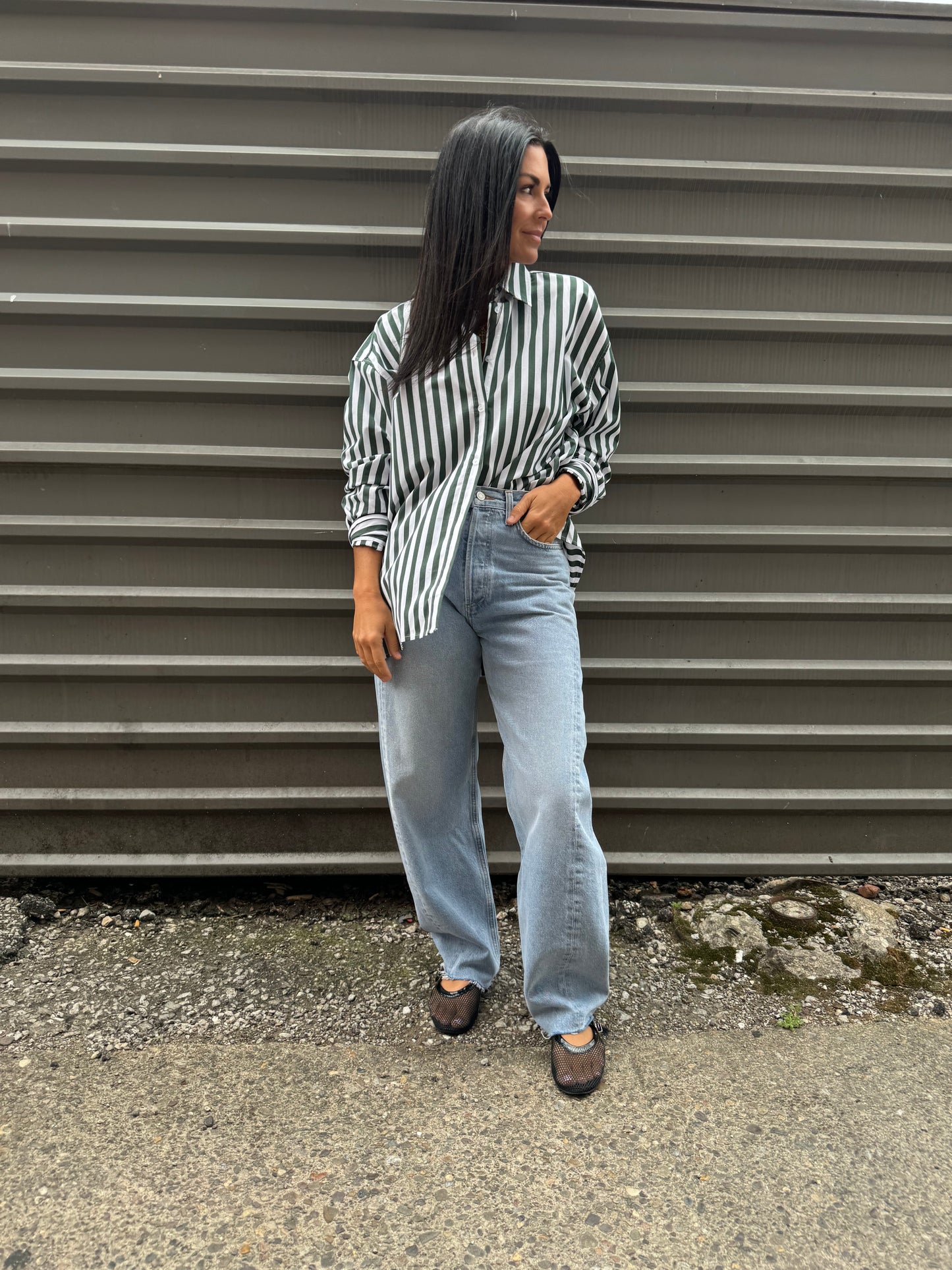 green striped button up shirt and baggy jeans outfit