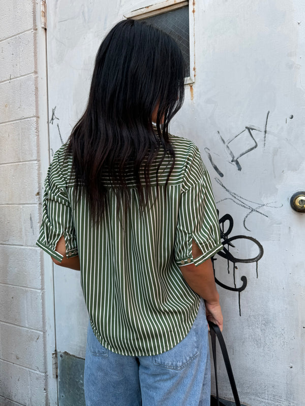 green striped button up and baggy denim jeans 