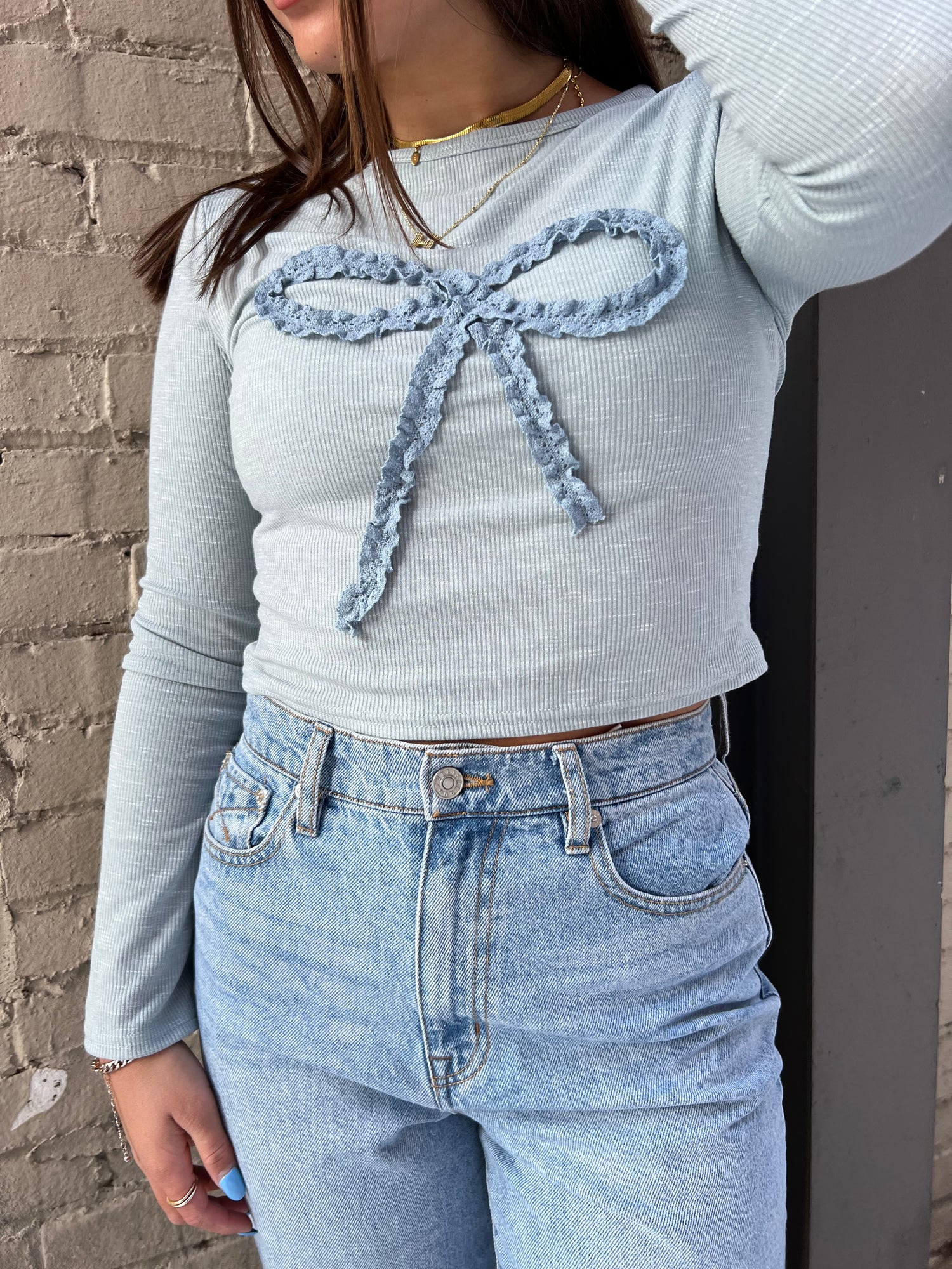 light blue top with crocheted bow