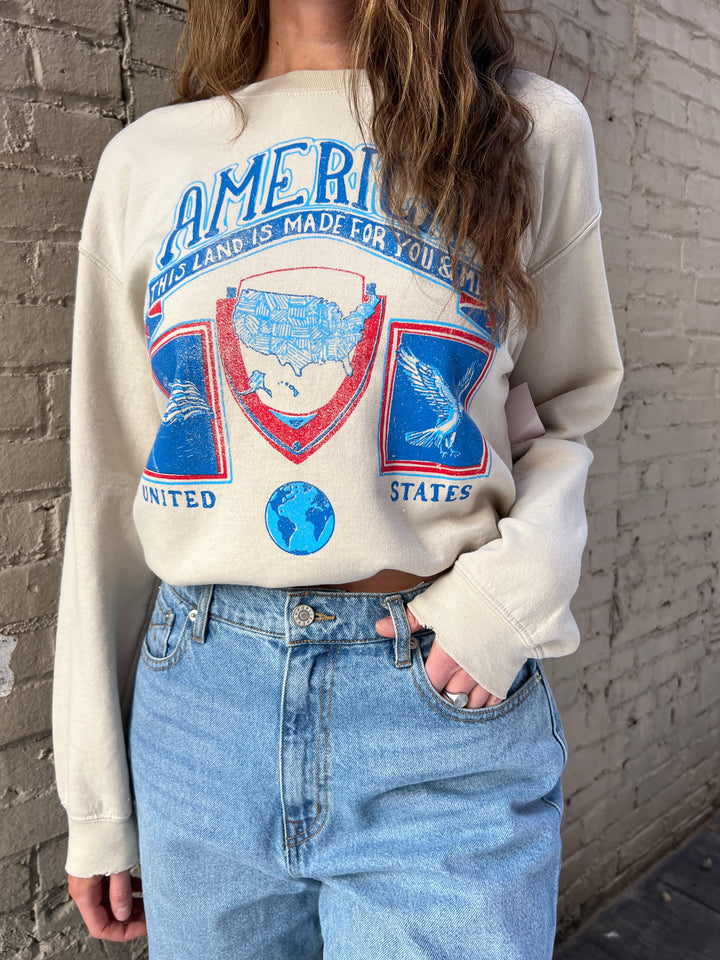 cream crewneck with blue faded graphic