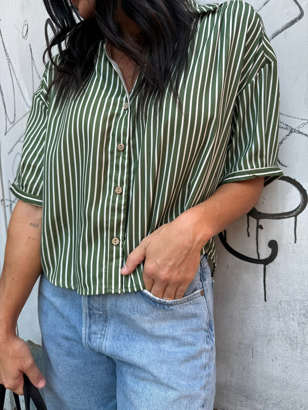 green striped button up and baggy denim jeans 