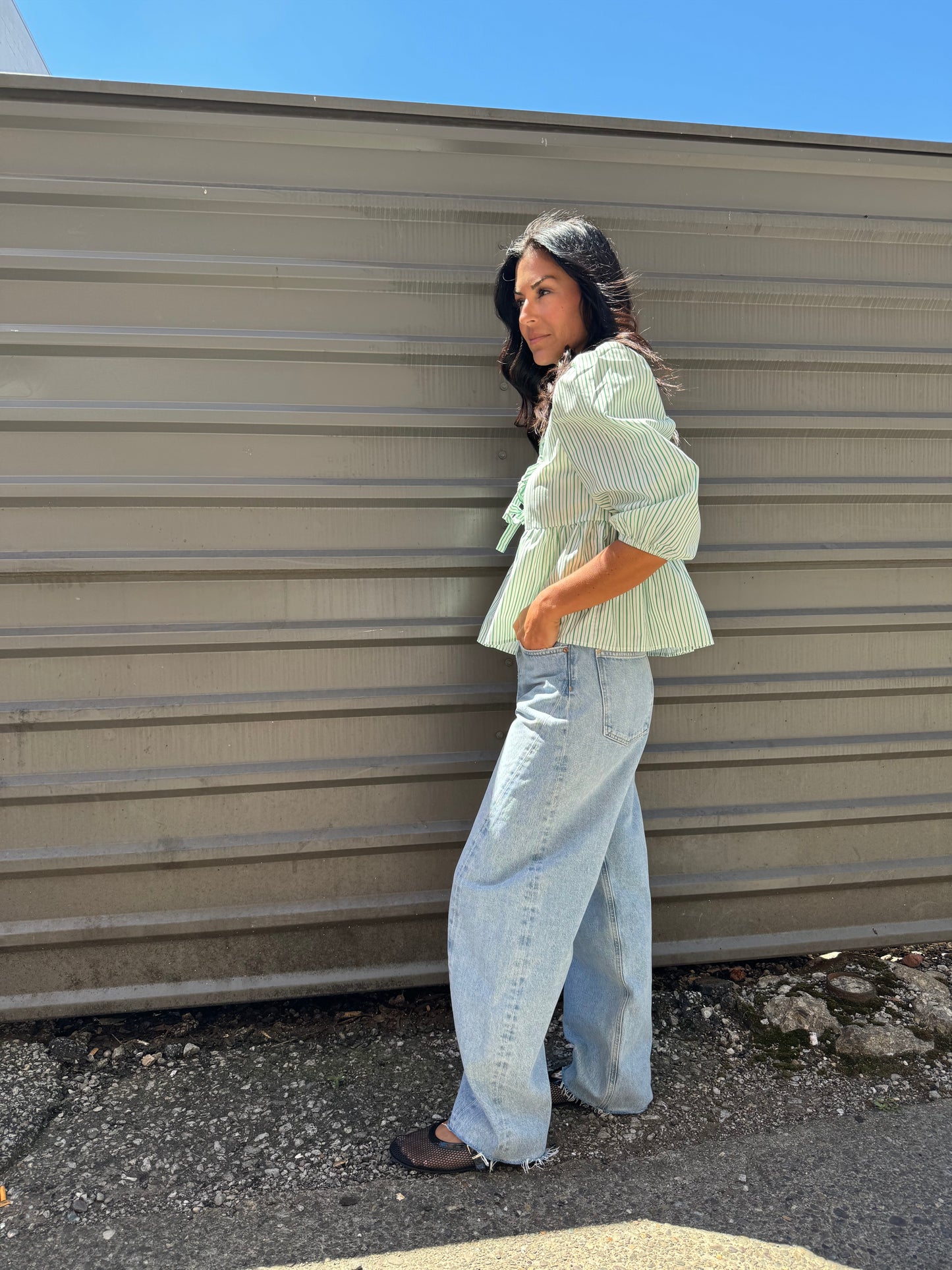 green striped puff sleeve peplum top and blue barrel jeans