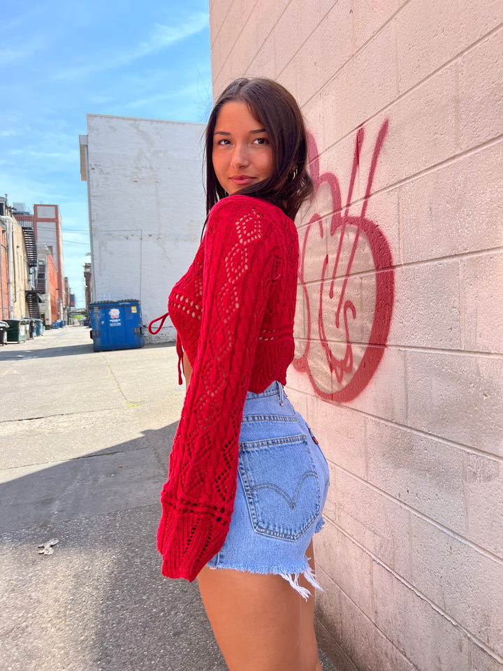 red crochet top and denim shorts