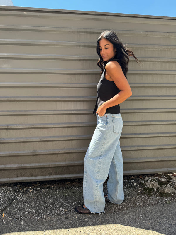 black vest top and blue barrel denim jeans