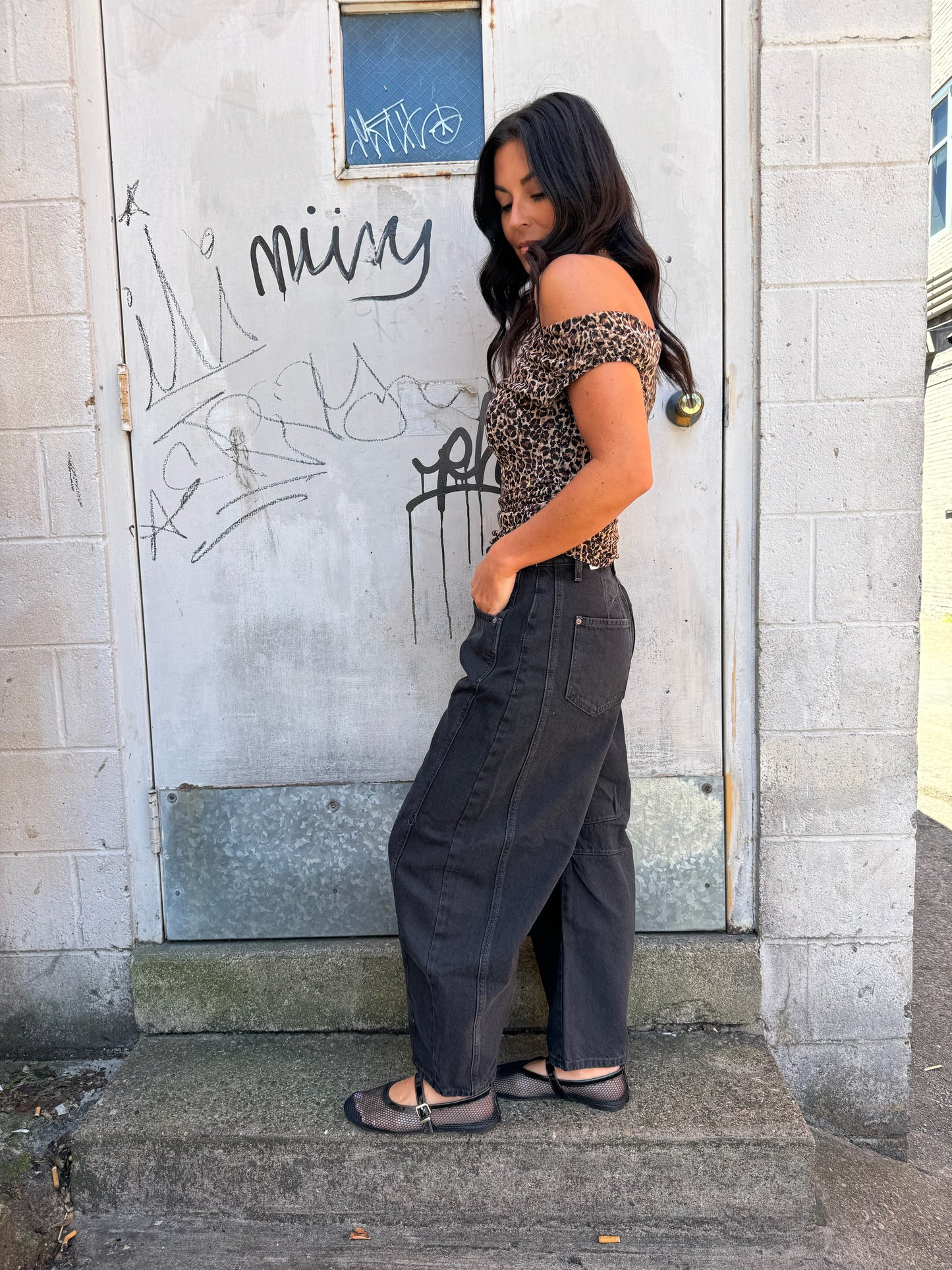 black leopard off shoulder top and black barrel jeans outfit