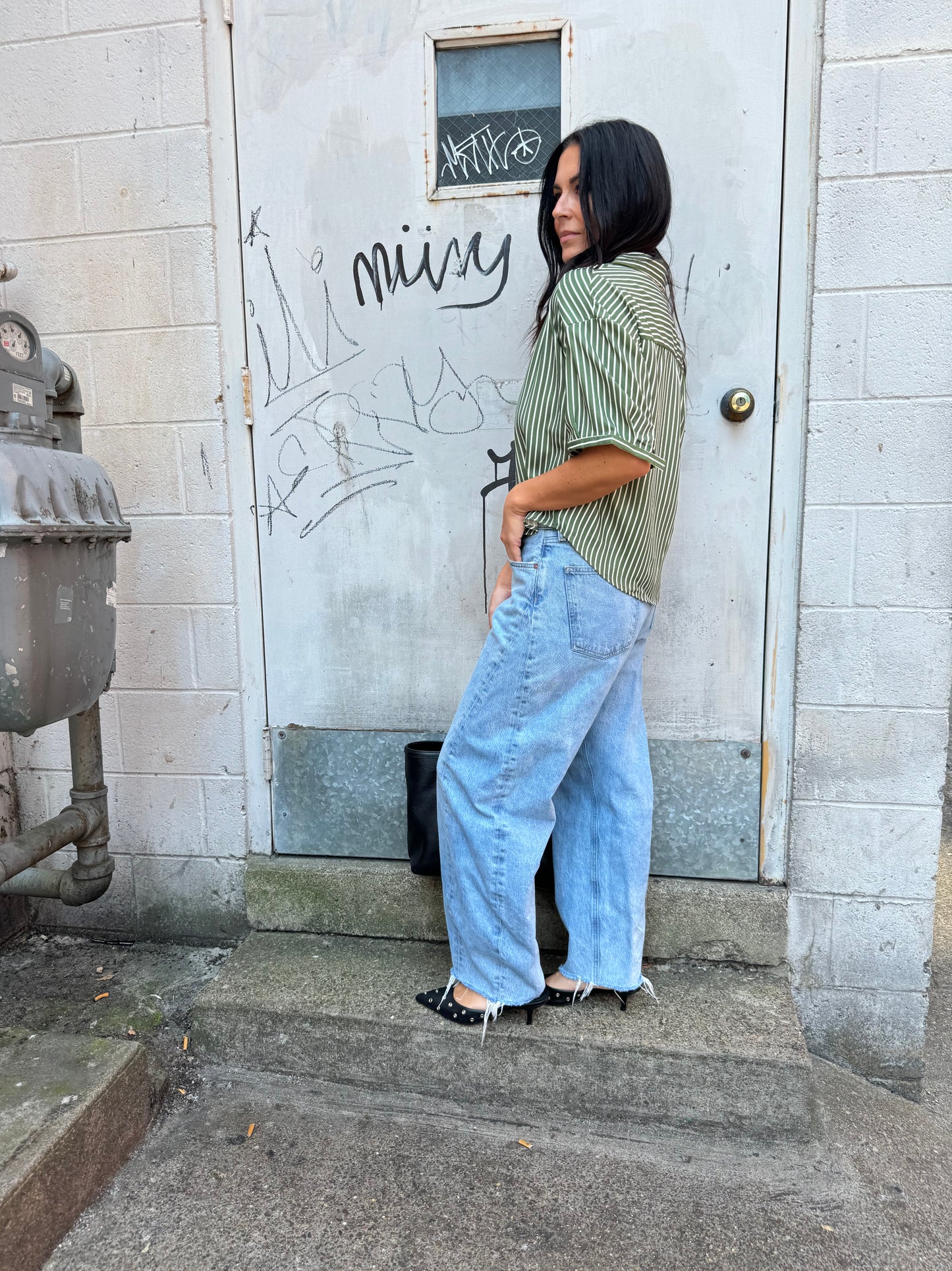 green striped button up and baggy denim jeans 