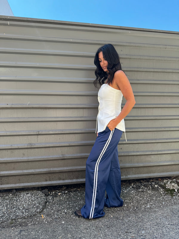 white vest and navy track pants outfit 