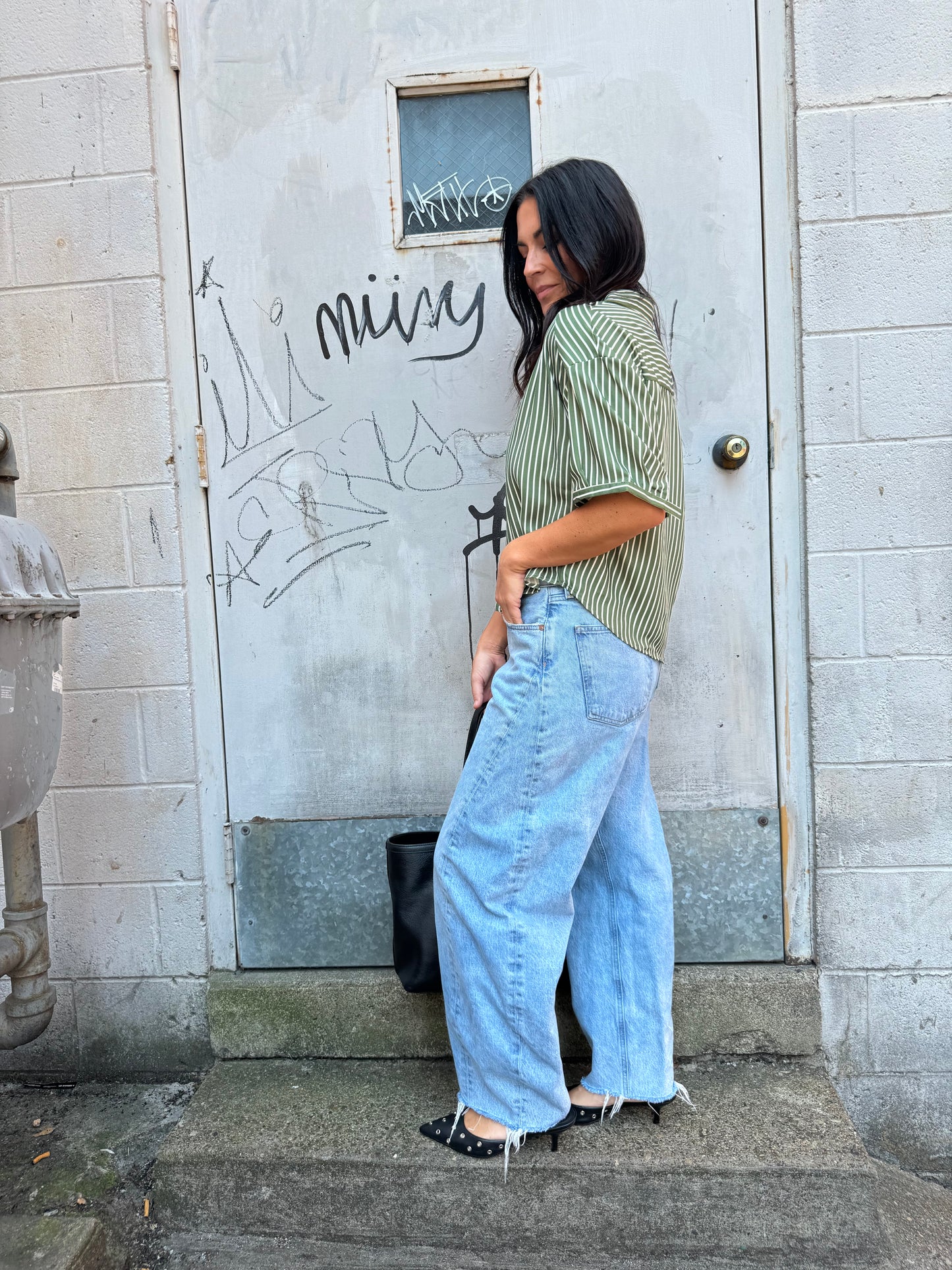 green striped button up and baggy denim jeans 