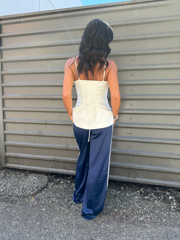 white lace up top and navy blue pinstripe track pants